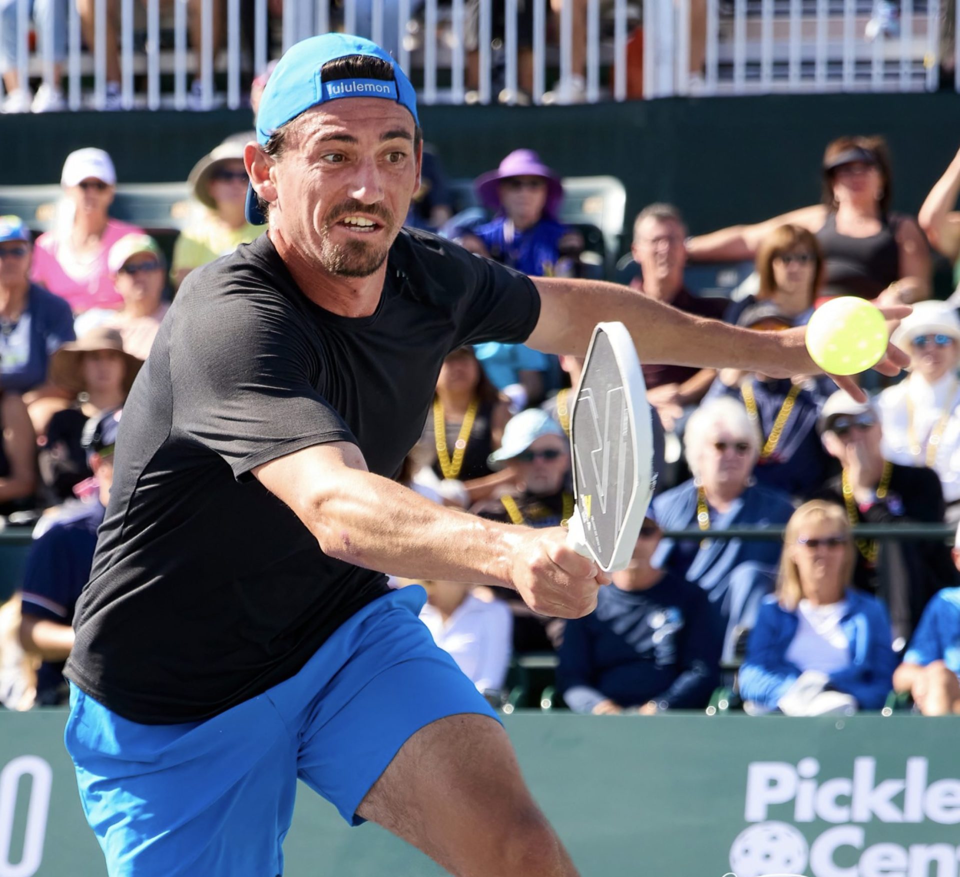 pickleball player trying to hit a pickleball 