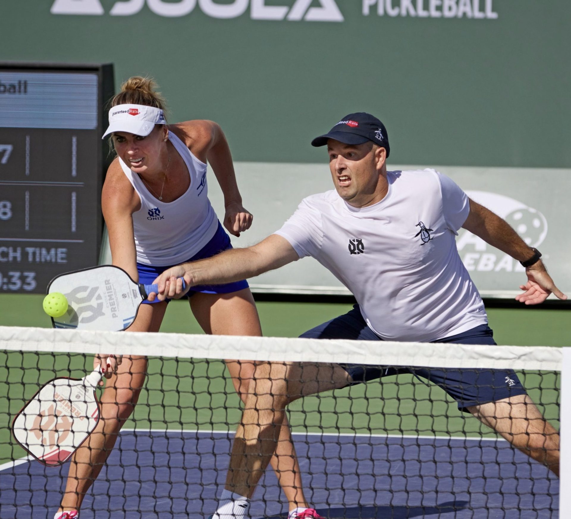 two pro players hitting the ball over a net