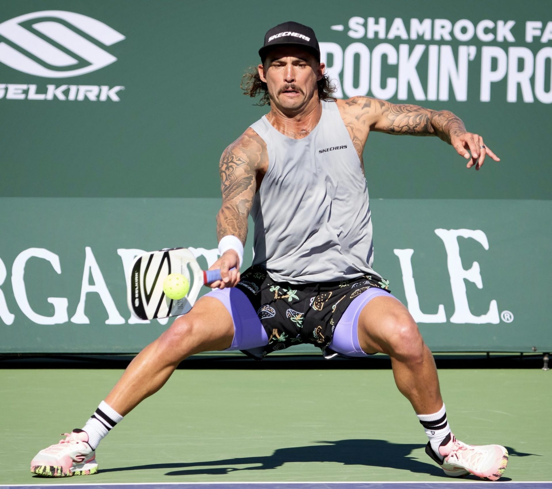 pro player hitting a pickleball