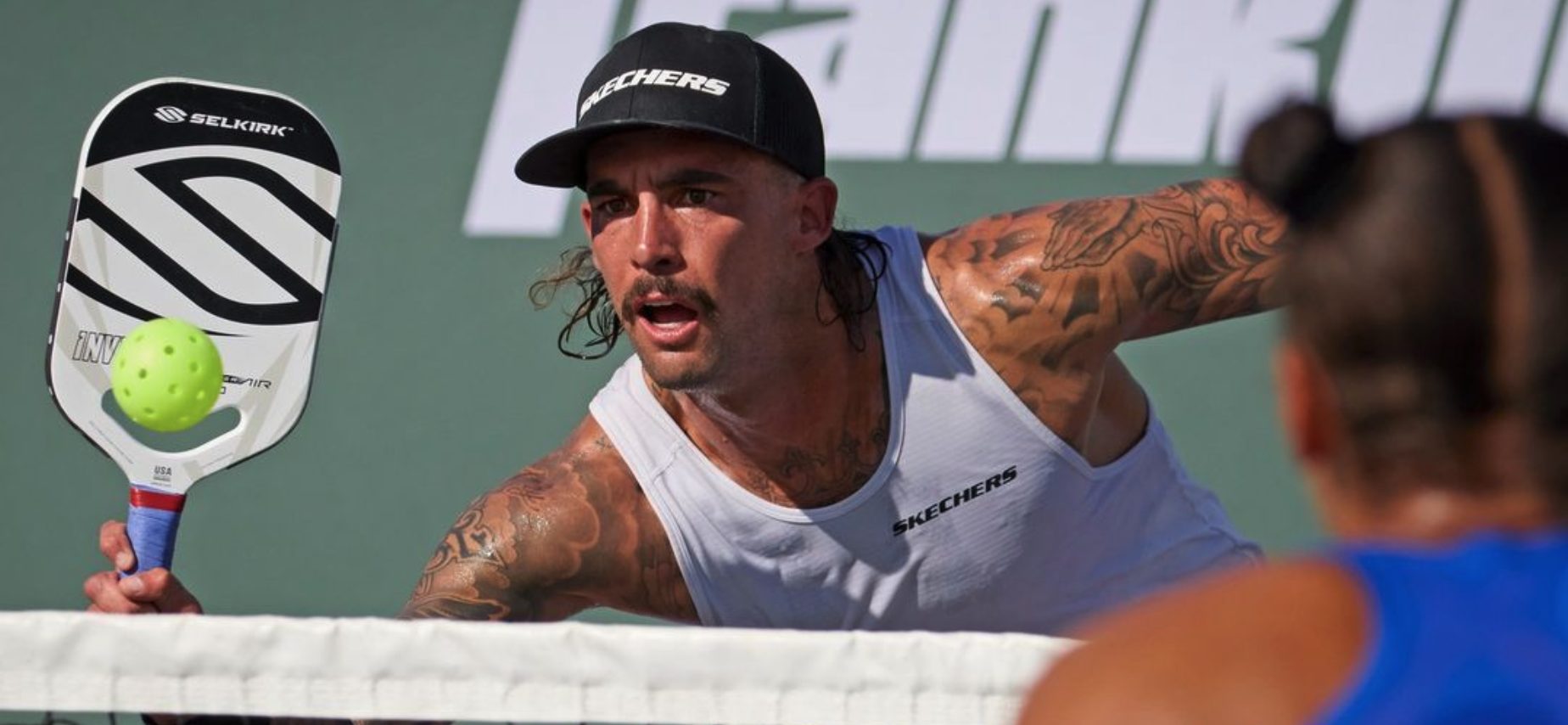 Pro player hitting a pickleball
