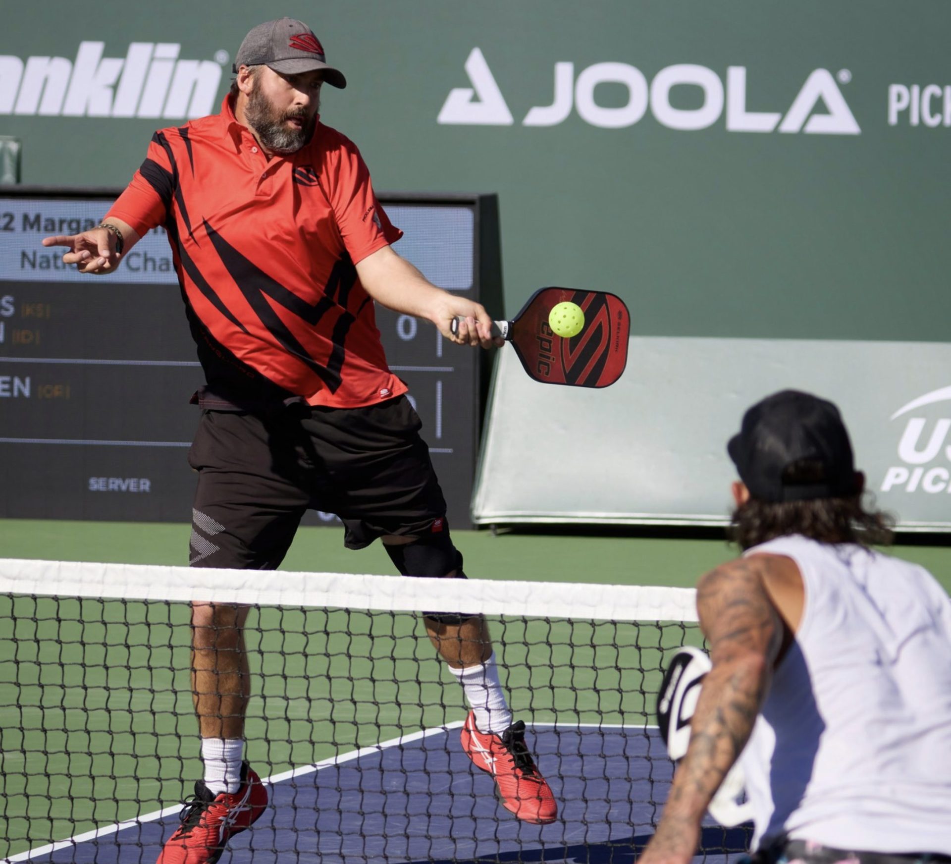 Pro player hitting a pickleball