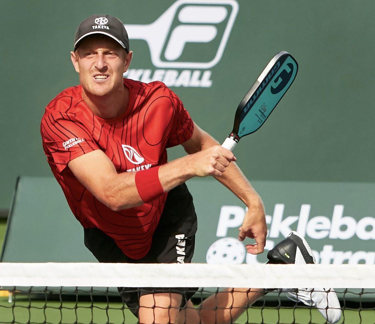 pro player hitting a pickleball