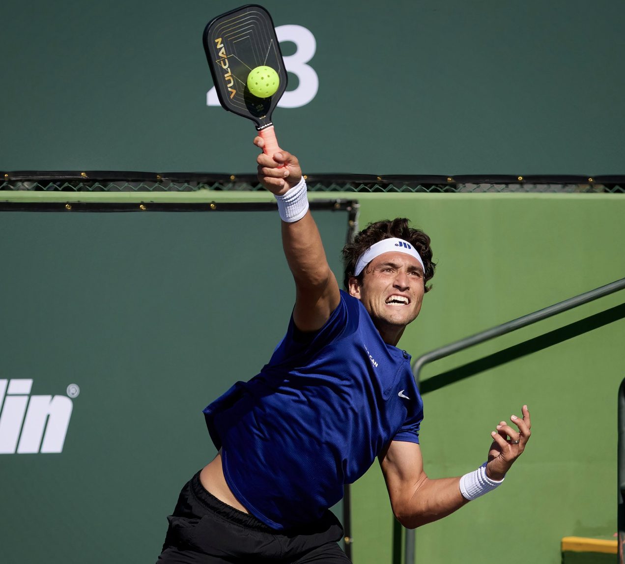 Pro player spiking the pickleball